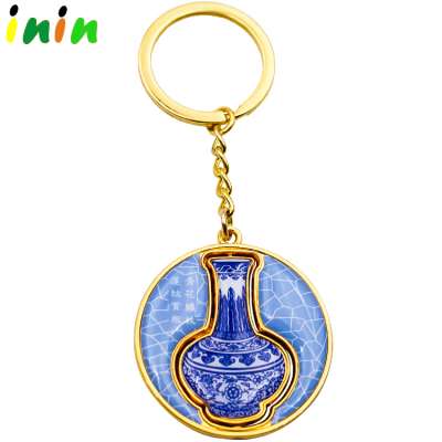 Zinc alloy blue and white porcelain laser logo gold rotating key chain